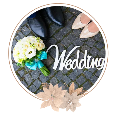 Bouquet of flowers, wedding tag, and matching man's and woman's shoes arranged in a frame