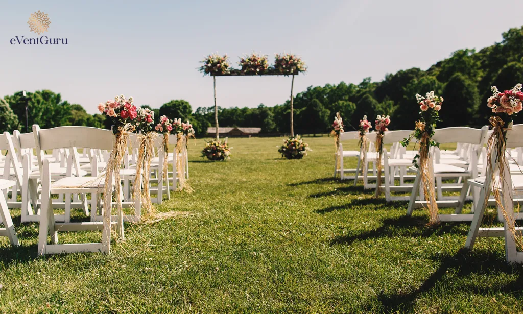 A wooden wedding altar with bouquet stands made from wooden sticks