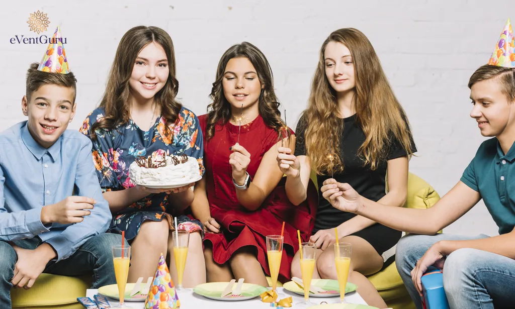 In front of a birthday girl holding a cake, friends hold firecrackers in their hands