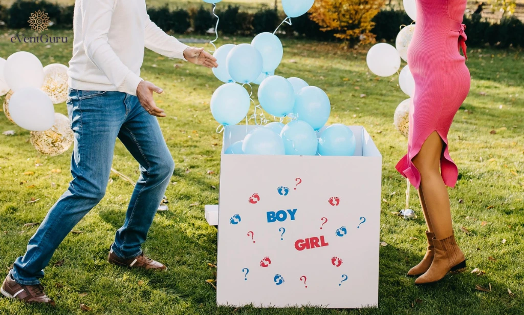 At a gender reveal party, a pregnant woman and a man open a box with blue balloons