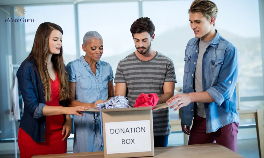 Clothing is being sorted in the office donation box by the business team