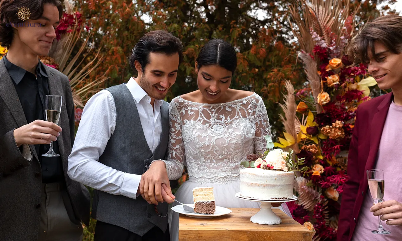 The front view of a smiling couple holding a cake