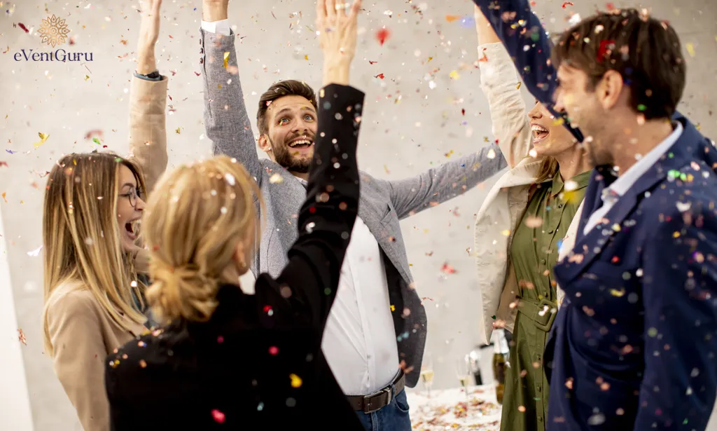 Business people celebrate and toast with confetti falling into the office