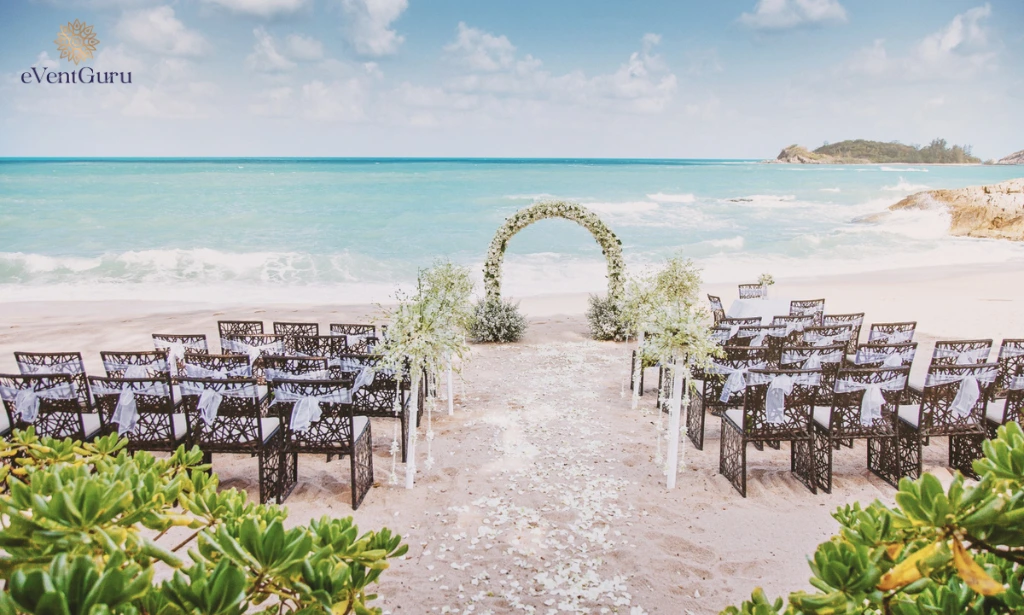 The beach wedding venue is beautifully decorated with flowers