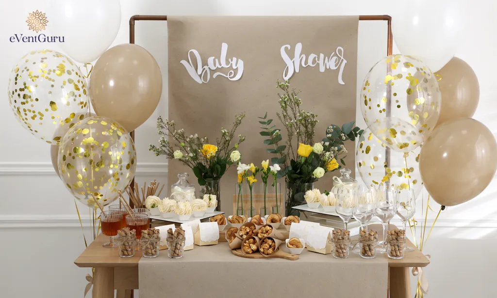 A table with tasty treats and drinks is available in the room. Baby shower party