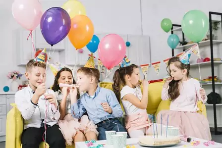 Party horns and colorful balloons are held by children
