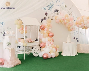 A beautifully decorated party with balloons in a large white tent