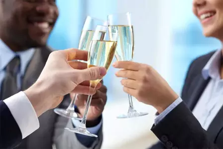 Business people celebrate their office party with wine